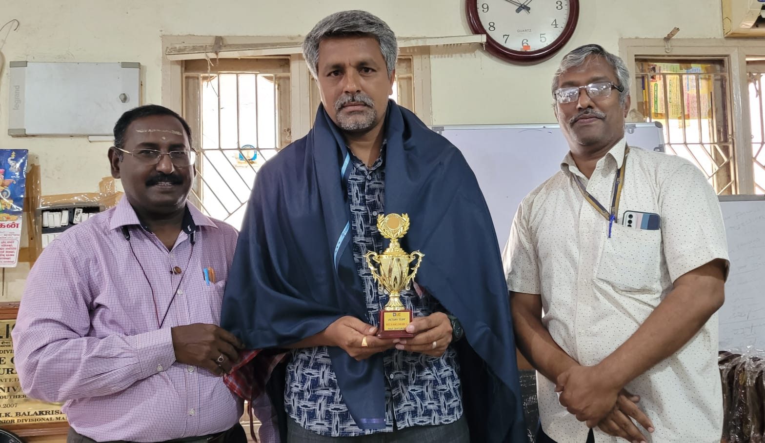 G. Selvakumar with a Victory Team Half Centurion trophy and shawl
