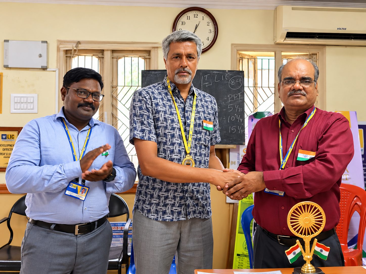 G. Selvakumar wearing a medal and shaking hands with a branch officer