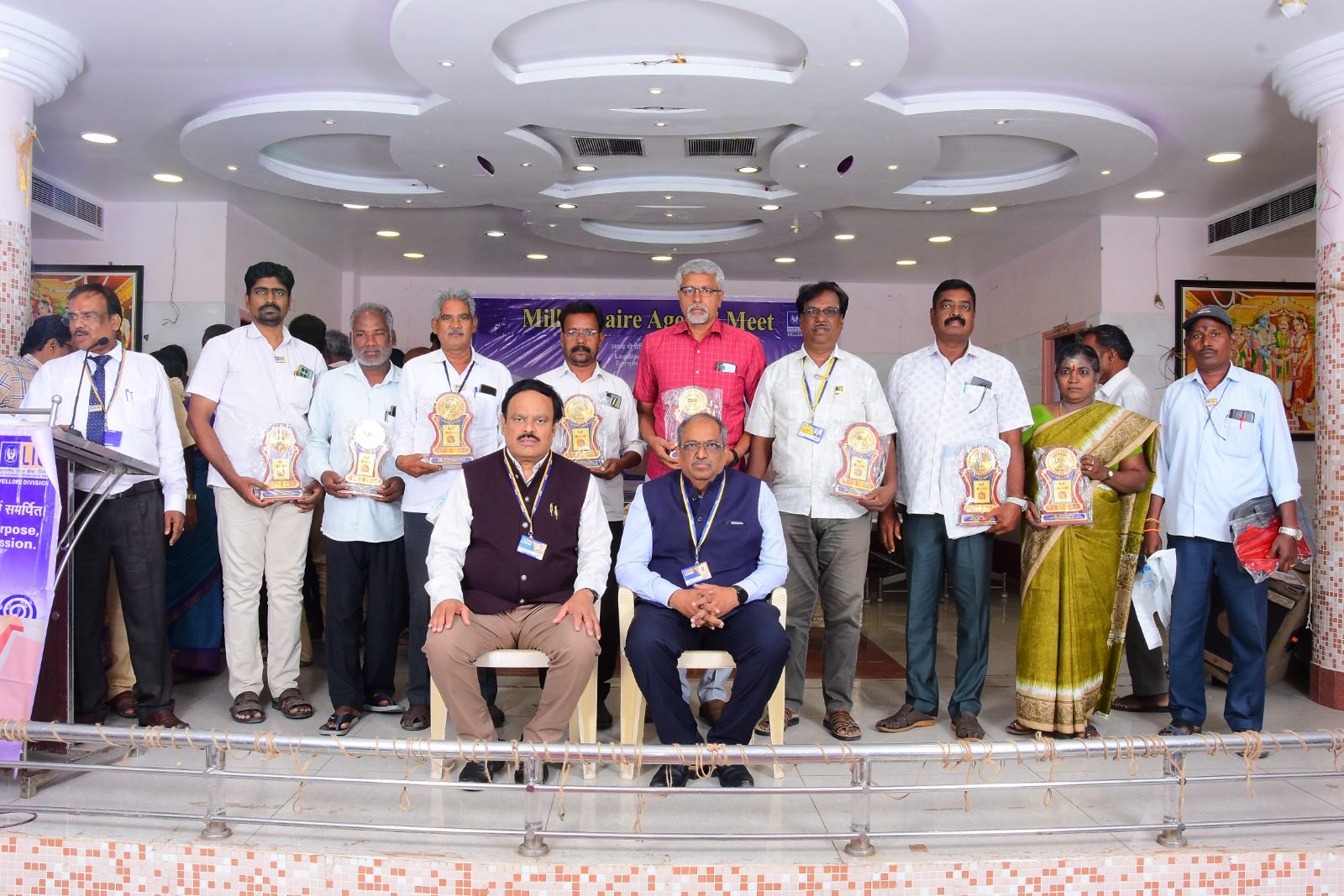 Group photo of agents holding plaques at the Millionaire Agents' Meet, Vellore Division