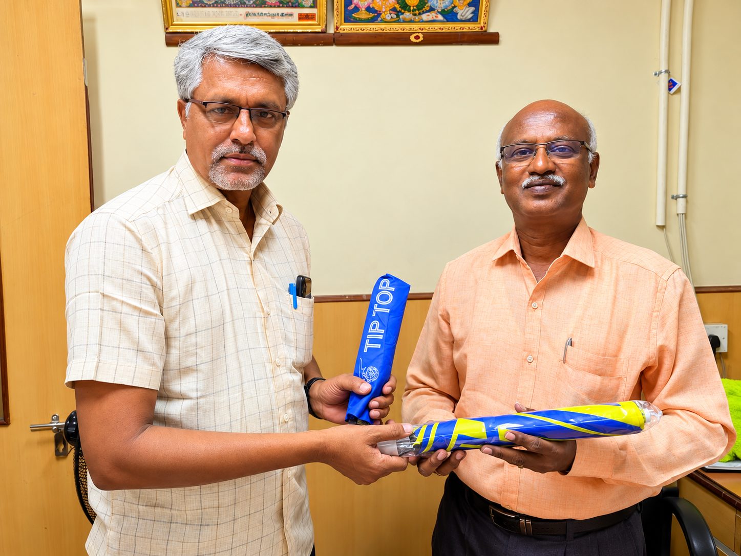 G. Selvakumar receiving an umbrella as a recognition gift